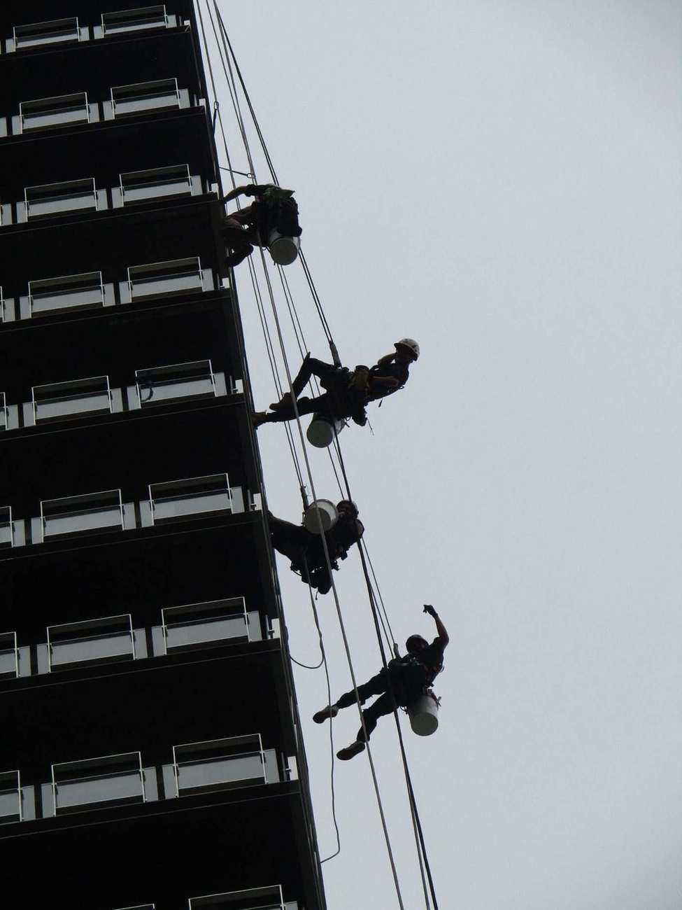 Mission Possible rope access technicians abseiling a high-rise building facade in Perth