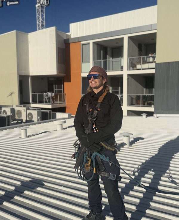 Tim Hemsley, Managing Director at Mission Possible, performing rope access work on a residential building