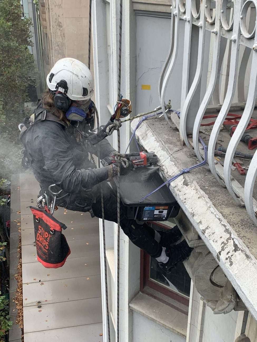 Mission Possible technician performing concrete repair work on a building facade